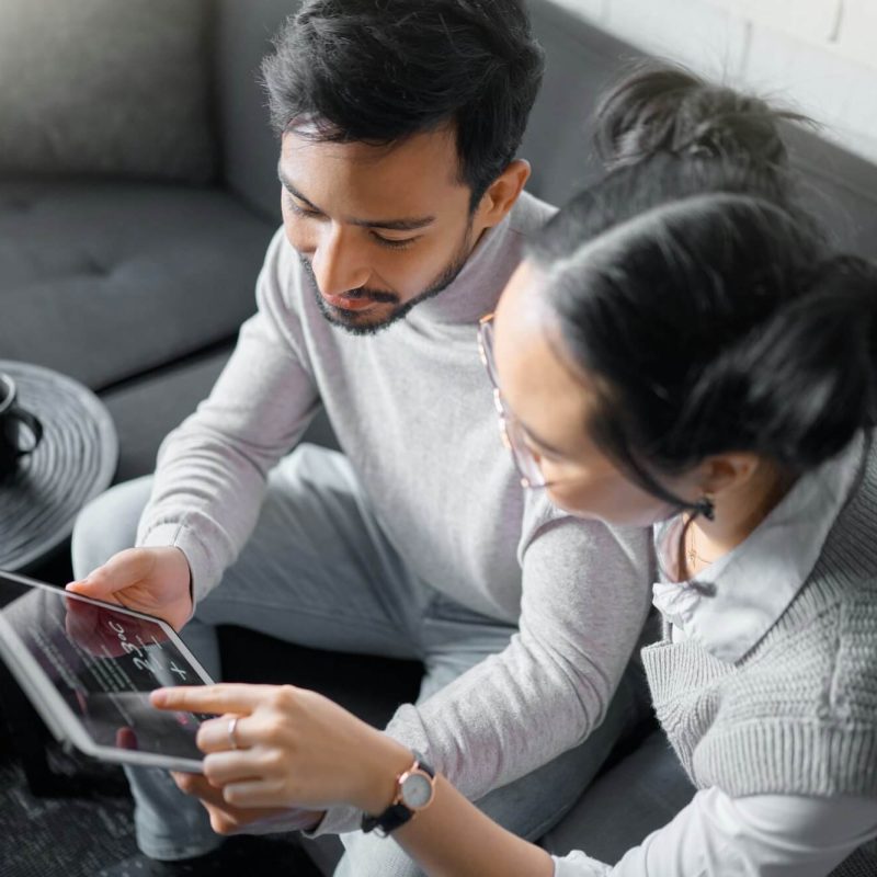 tablet-sofa-and-couple-with-smart-home-technology-for-thermostat-heating-apartment-security-netwo.jpg